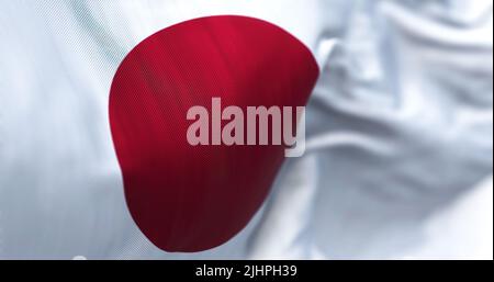 Close-up view of the Japanese national flag waving in the wind. Japan is an Asian country. Fabric background Stock Photo