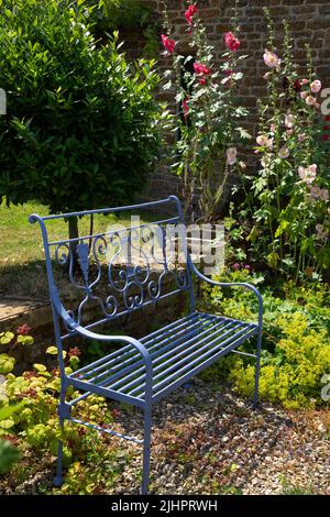 metal garden bench in english garden,England Stock Photo