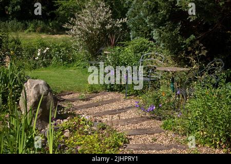 English garden path made with gravel and wooden sleepers Stock Photo