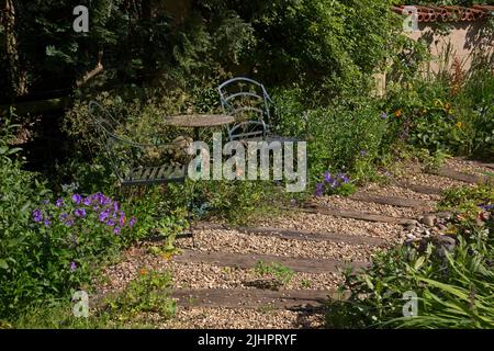 English garden path made with gravel and wooden sleepers Stock Photo