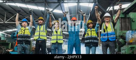 Teamwork of engineer, successful of happy engineering people working in factory industry show hand up Stock Photo