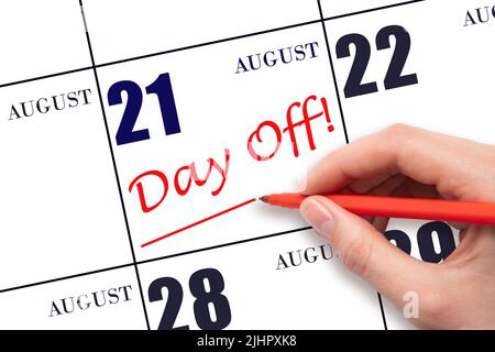 21st day of August. Hand writing text DAY OFF and drawing a line on calendar date 21 August. Vacation planning concept. Summer month, day of the year Stock Photo