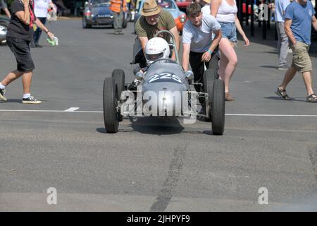 A silver Cooper Mk8 number 225, 500cc engine, being pushed to the start line at the Shelsey Walsh Classic Nostalgia event in July 2022 Stock Photo