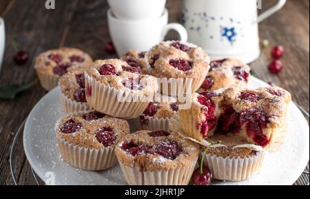 Plate with muffins on wooden table Stock Photo