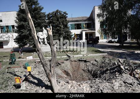 DRUZHKIVKA, UKRAINE - JULY 9, 2022 - The crater from a Russian shell is pictured at a playground, Druzhkivka, Donetsk Region, eastern Ukraine. This ph Stock Photo