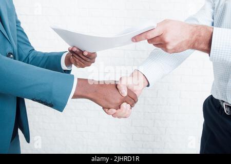 Shaking hands after signing business contract Stock Photo