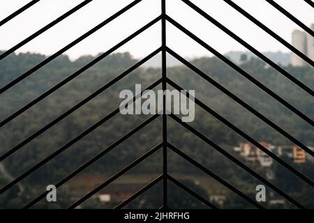 Close up iron bars or metal grating on window. Bright blurred outdoor background, copy space. Stock Photo