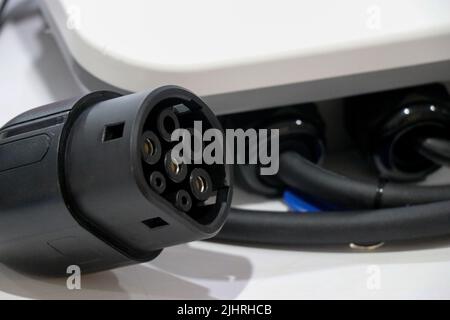 An Electric car charger plug of type 2 with its panel on a white background, EV or electric vehicle Charging Connector type 2 Stock Photo