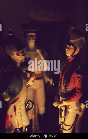 Porcelain Figurine soldiers acting as if they were talking at night over camp fire. Stock Photo