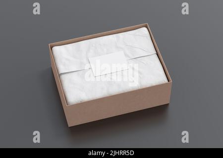 Gift box mock up. Cardboard gift box with blank label or business card on wrapping paper. Black background. Side view Stock Photo