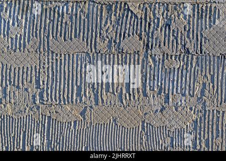abstract uneven embossed textured concrete wall, stone material texture closeup diversity Stock Photo