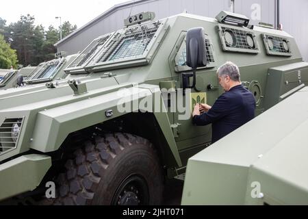 The fifth president of Ukraine, Petro Poroshenko, sticks the emblem of the Poroshenko Foundation and other volunteer organizations on the side of an armored car. The armoured vehicles bought by the Poroshenko Foundation together with volunteers, are already near the Ukrainian border and will soon be at the front. The 11 brand new armoured vehicles of the NATO standard are at the Polish border and this is the first time new combat armoured vehicles are sold to volunteers and benefactors, Poroshenko said. (Photo by Mykhaylo Palinchak/SOPA Images/Sipa USA) Stock Photo