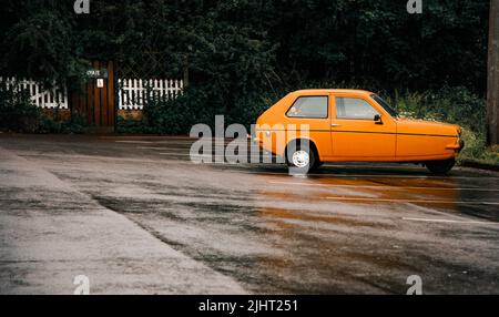 Old Three Wheel Car left on a quiet car park Stock Photo