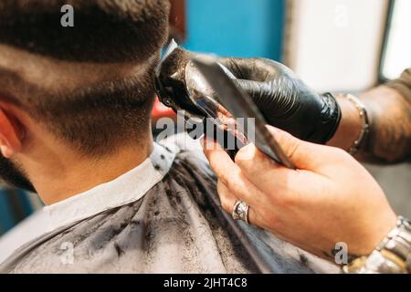 Man making curly haircut at barber shop closeup Stock Photo