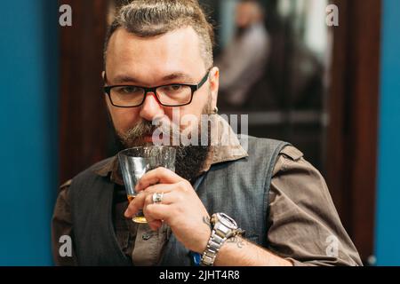 Bearded man drinking whiskey portrait Stock Photo