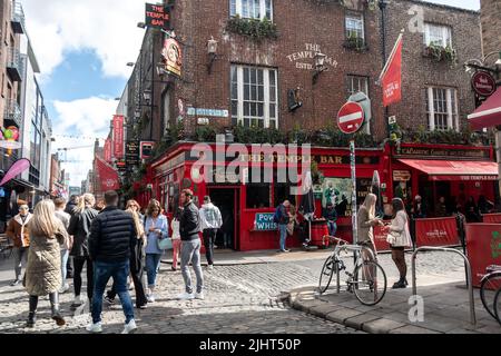 Dublin, Ireland - March 24, 2022: Crowds of tourists gather in Dublin's Temple Bar neighbourhood, a colourful downtown area of the city. Stock Photo