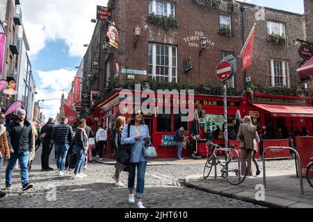 Dublin, Ireland - March 24, 2022: Crowds of tourists gather in Dublin's Temple Bar neighbourhood, a colourful downtown area of the city. Stock Photo