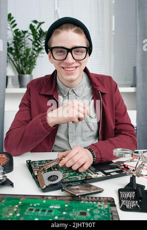 Attractive repairman in glasses smiling at camera Stock Photo