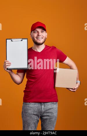 Delivery man holding clipboard and empty cardboard box Stock Photo