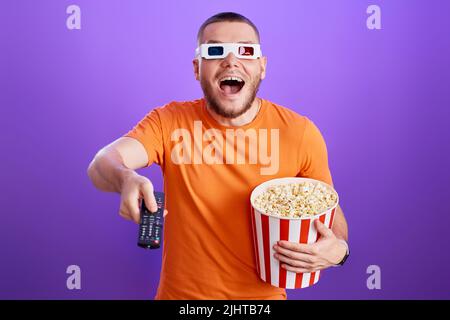 man in 3d glasses using console watching movie Stock Photo