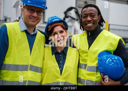 Three robotics engineers posing together in a company photo Stock Photo
