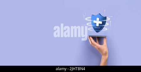 Businessman hold Shield with plus Low polygonal icon, medicine icon.Health shield.Medical logo template,protection symbol with cross sign,healthcare s Stock Photo