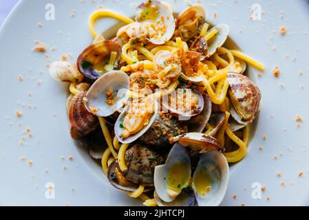 Traditional Italian food. Spaghetti ai frutti di mare - spaghetti with seafood. Bergamo, Lombardy, Italy, Europe Stock Photo