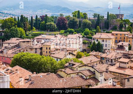 Seen from the Torre Civica, civic tower. Roofs of the upper city, in the background the fortress Rocca di Bergamo. Bergamo, Lombardy, Italy, Europe Stock Photo