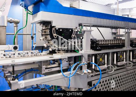 PET Dairy bottles blowing. The plastic bottle blowing machine.Heating process for plastic bottle process. Stock Photo