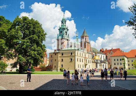 KRAKOW, POLAND - AUGUST 2021: The Wawel Royal Castle, a castle residency located in central Krakow. Tourists exploring the Wawel Hill, the most histor Stock Photo