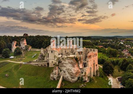 Aerial sunset view of Ogrodzieniec Castle, a ruined medieval castle in the south-central region of Poland, situated on the top of Castle Mountain, the Stock Photo