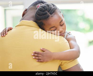 Daddy will always be here you, princess. an adorable little girl hugging her father during a day at home. Stock Photo