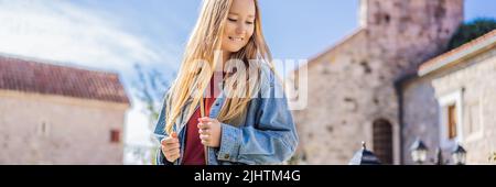 Young woman tourist in the old town of Budva. Travel to Montenegro concept BANNER, LONG FORMAT Stock Photo