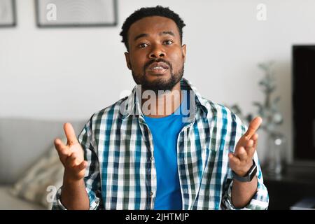 Serious Bearded African American Man Talking Communicating Sitting At Home Stock Photo