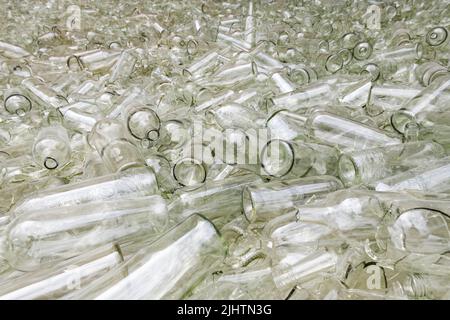 Large pile of broken and whole large glass bottles in preparation for recycling Stock Photo