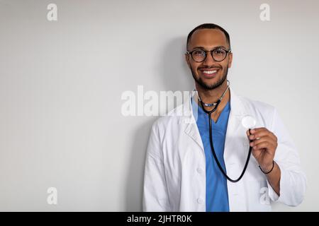 Portrait of cheerful arab doctor holding stethoscope Stock Photo