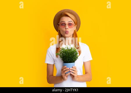 Woman planting flowers in pot. Girl hold flower pot. Concept of growing plants. Summer female gardener. Stock Photo