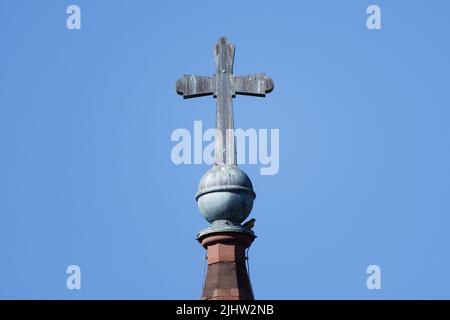 cross on the spire of a protestant church in cologne Stock Photo