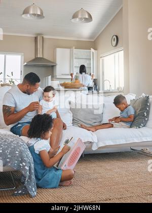 Typical Sundays. a young family relaxing together in the lounge at home. Stock Photo