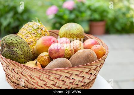 A larget basket filled with a variety of tropical fruit. Stock Photo