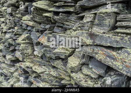 stone wall background from weathered slate stones Stock Photo