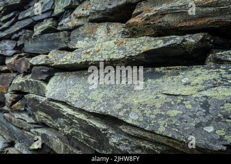stone wall background from weathered slate stones Stock Photo