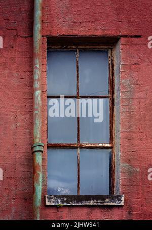 An old window is pictured at the old Mobile County Co-Op, July 17, 2022, in Grand Bay, Alabama. Stock Photo