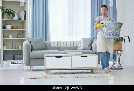 Doing chores is free therapy. a young woman cleaning up at home. Stock Photo