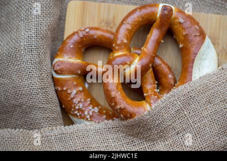 Close-up of Bavarian salty pretzel on burlap on table Stock Photo