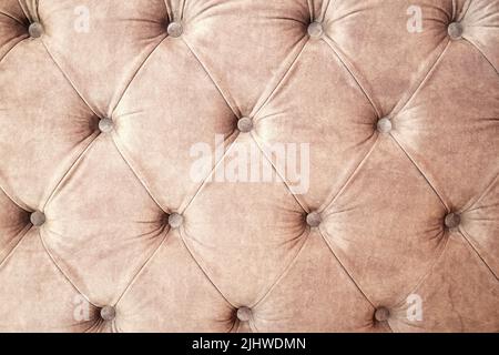 Background texture of draped sofa back with velveteen and buttons. Abstract interiors backgrounds Stock Photo