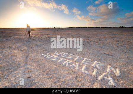 A woman walking on the rare shell beach with sunrise in Western Australia Stock Photo