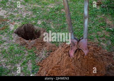 Well dug in the sandy soil. Tool for making round holes. artificial well. Stock Photo