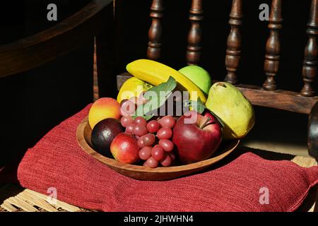 Artificial fruit tray on a chair Stock Photo