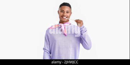 Young African-American guy with chewing gum on white background Stock Photo